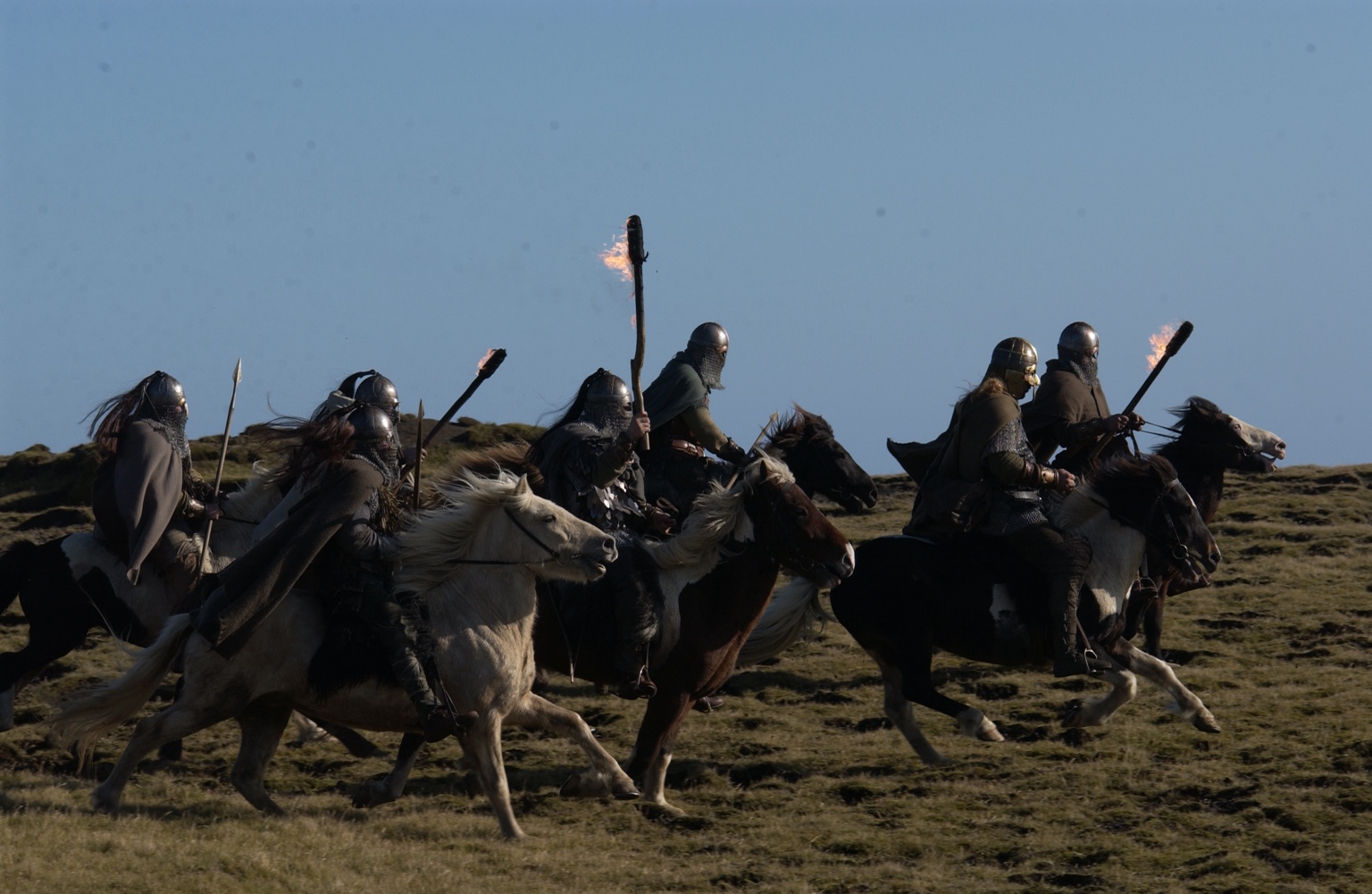 Mounted warriors riding with flaming torches
