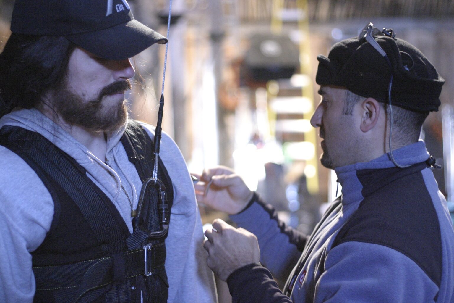 Peter Pedrero in conversation with a performer on set