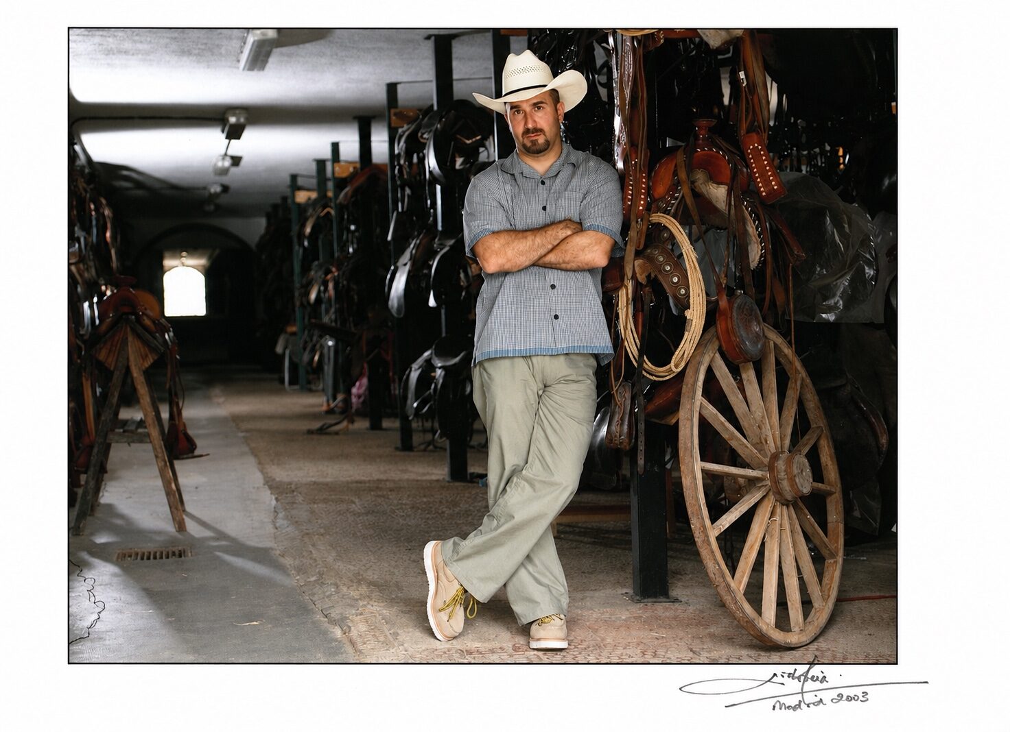 Peter Pedrero in Western costume beside production props