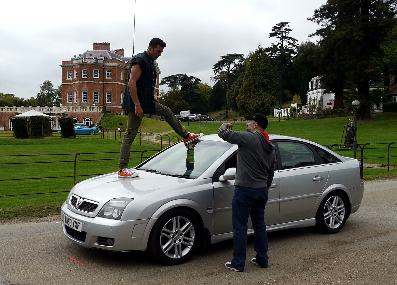 Action rehearsal beside a car