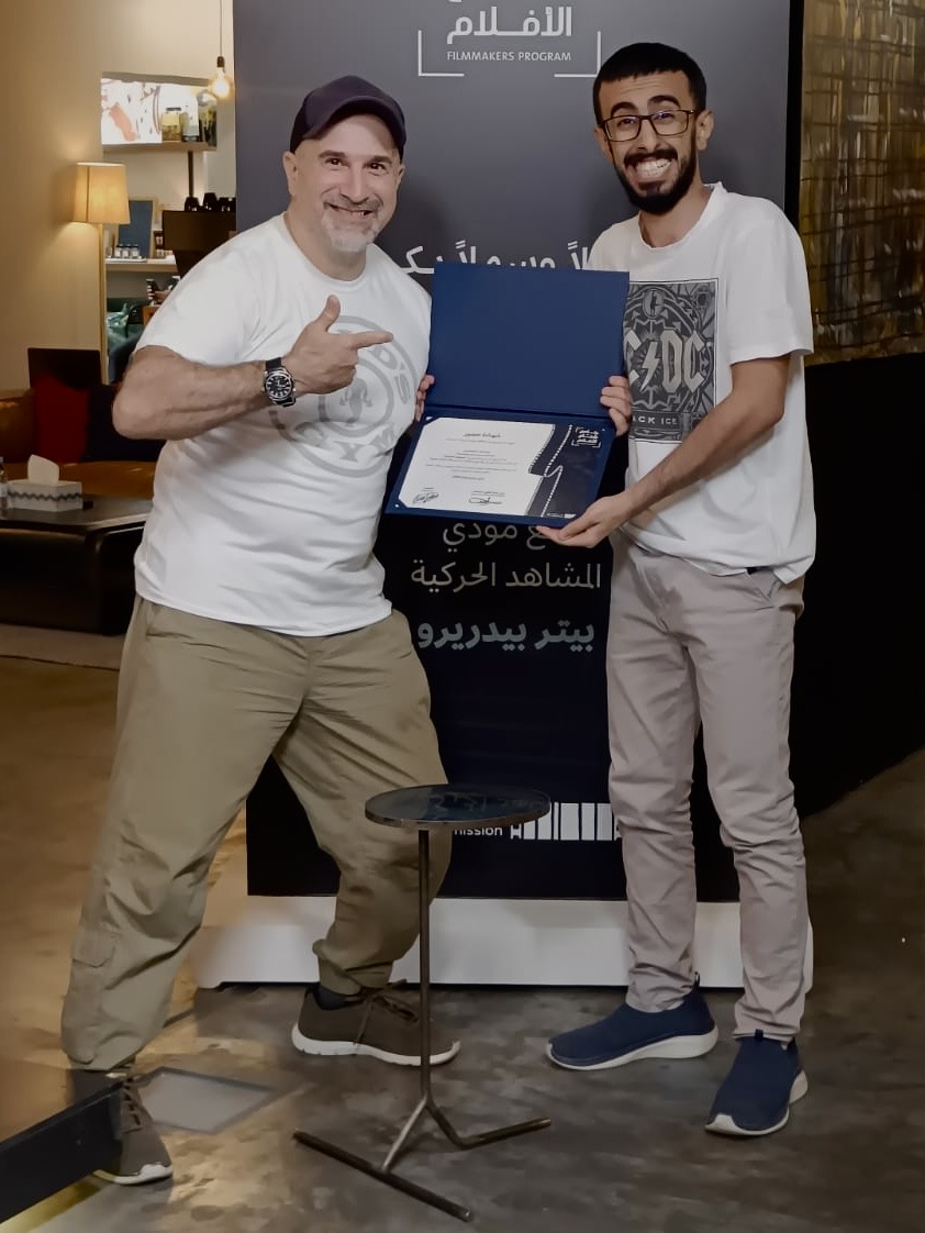 Peter Pedrero presenting a course completion certificate in Saudi Arabia