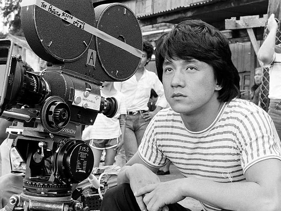 Jackie Chan beside a film camera